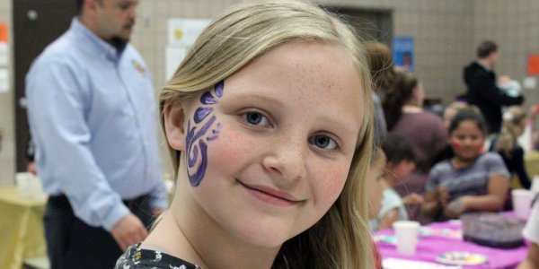 Young girl with her face painted.