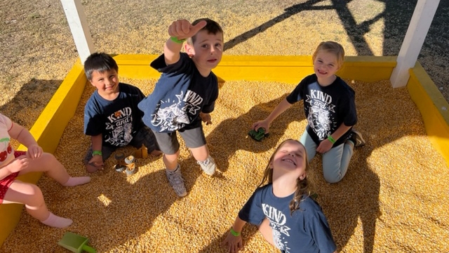 Children playing in a "cornbox."