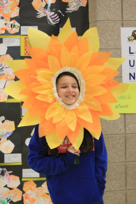 Student with flower frame around her face.