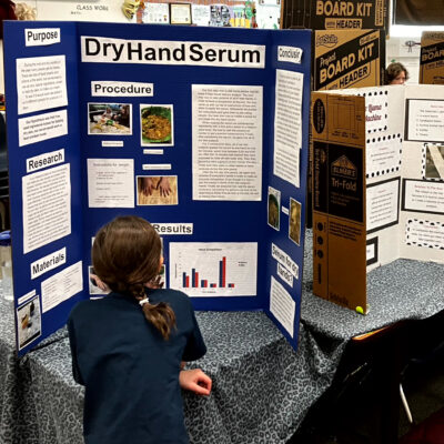 Young student exploring a STEM display.