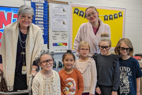 Teachers and students dressed as if they are 100 years old.