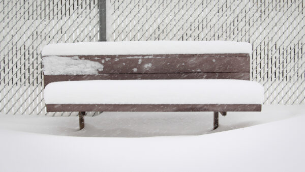 Kindergarten bench covered in snow.