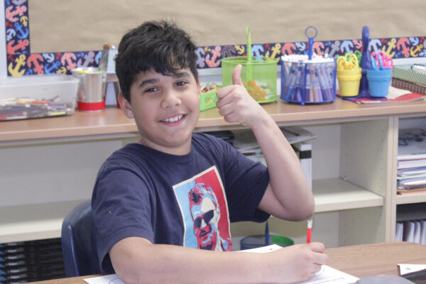 Student giving a thumbs up.
