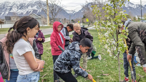Students planting tree.