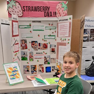 Young boy with STEM Fair project.