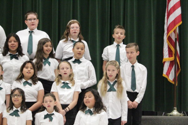 School choir - white shirts and green ties.
