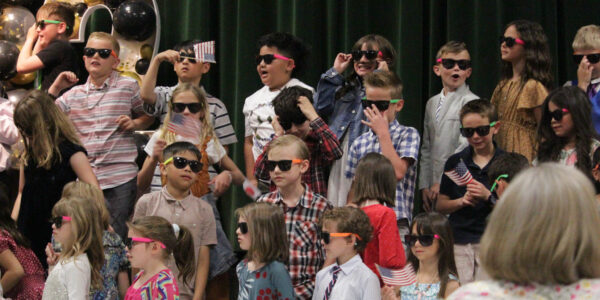 Children performing with sunglasses.