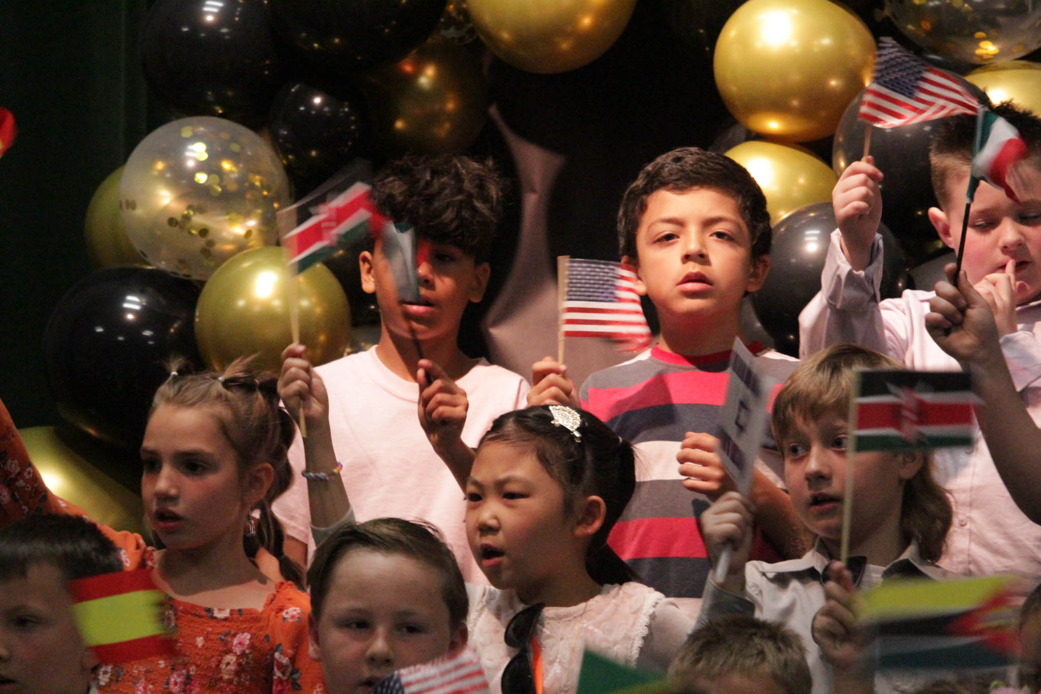 Second grade students with flags.