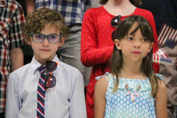 Young boy and girl waiting to sing.
