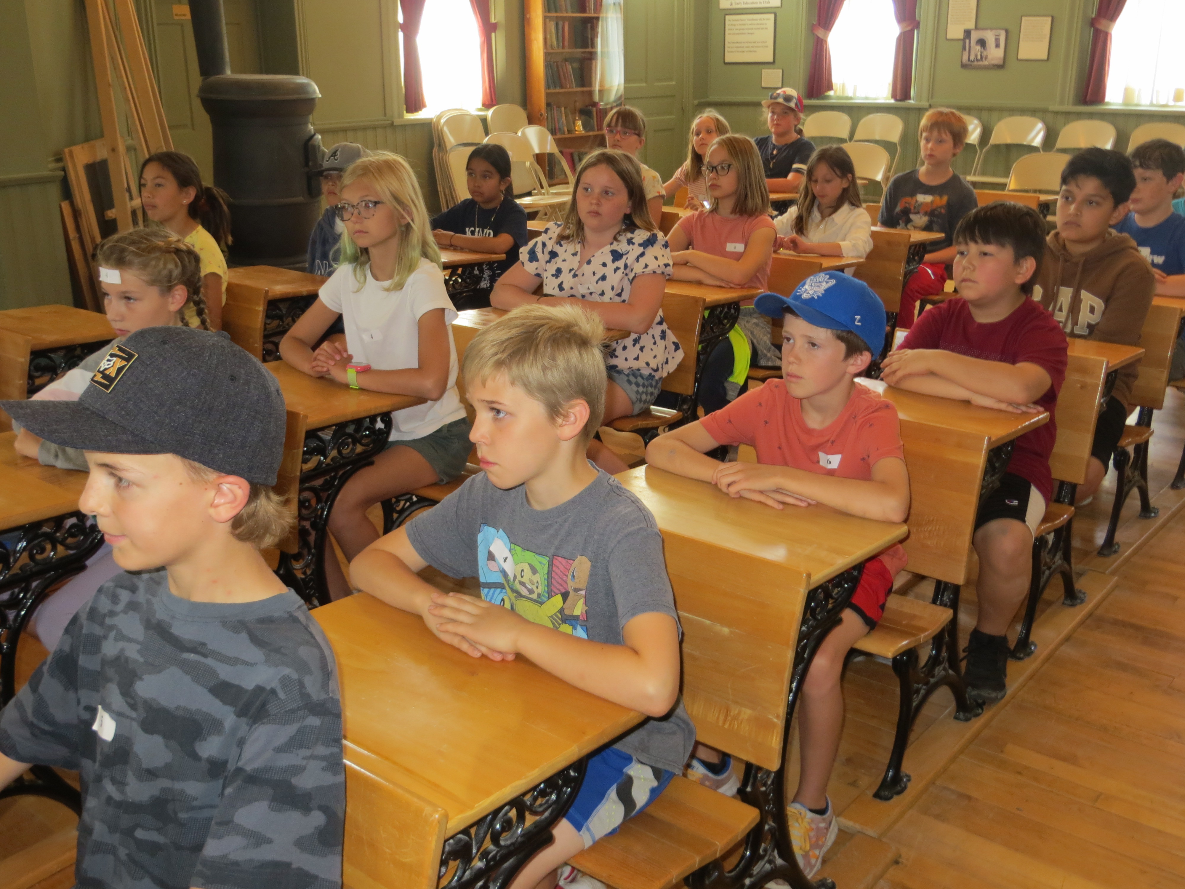Students sitting at desks in old school room.