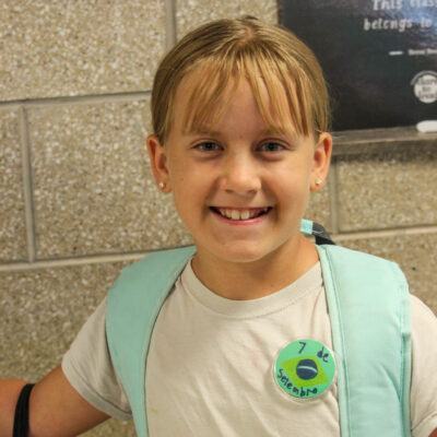 Fifth grade student displaying their Indendence Day button.