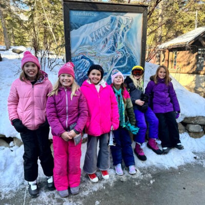 Students posing near the Sundance Resort map.