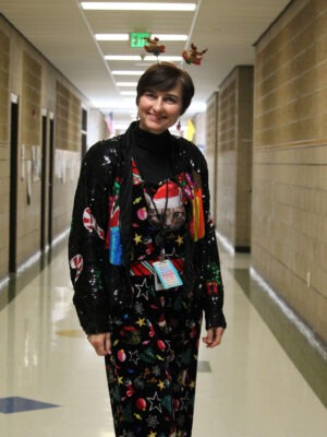 Teacher decked out from head to toe in Christmas clothing.
