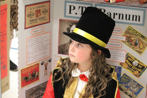 Young girl dressed as P. T. Barnum.