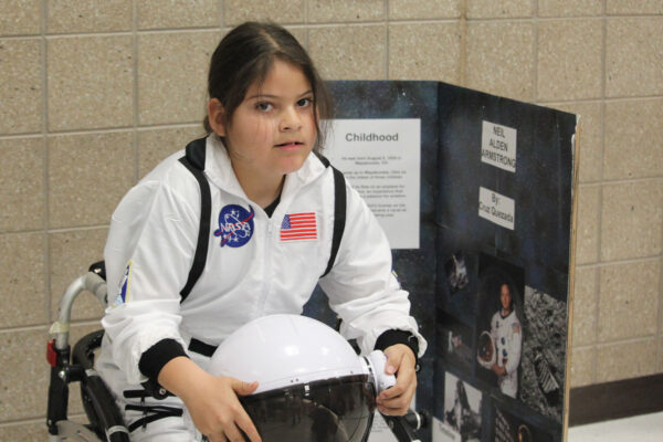 Young boy dressed as Neil Armstrong.