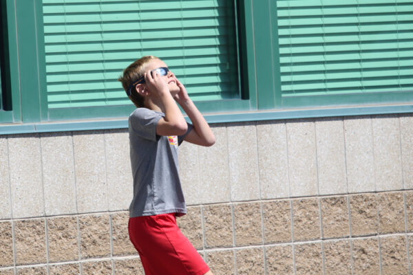 Young boy watcing the eclipse.