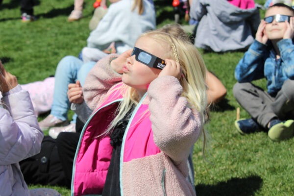 Young girl watching eclipse.