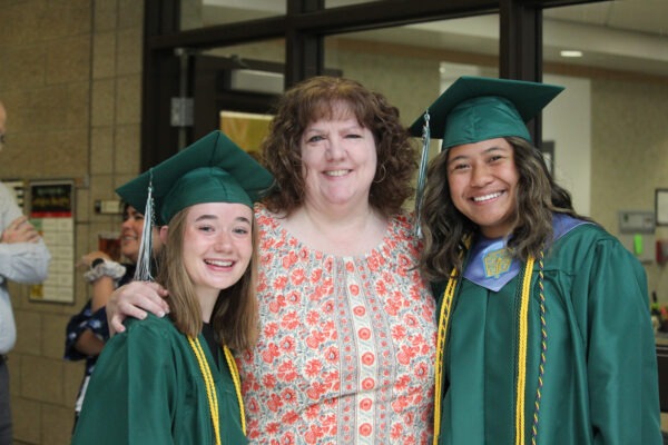 Mrs. Baer with two graduates.