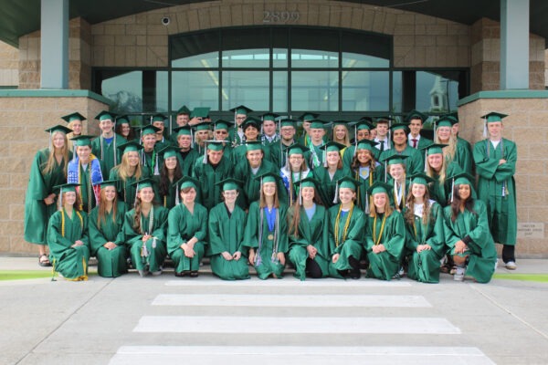 Provo High graduates posing in front of Lakeview School.