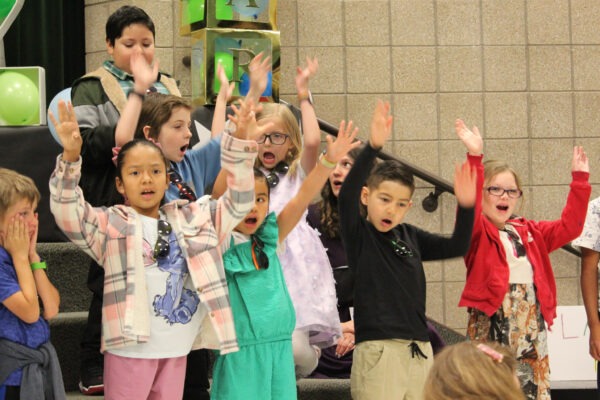 Children cheering during song.