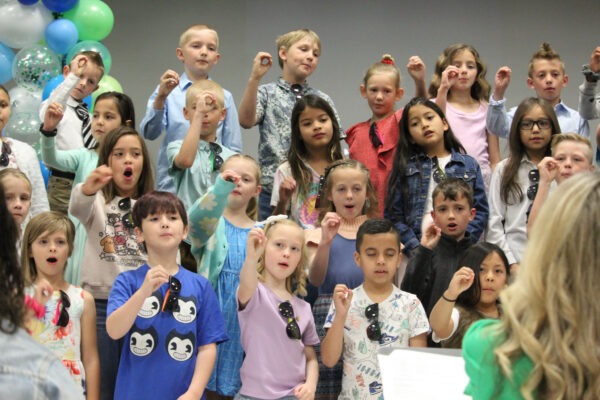 Children cheering during song.