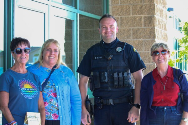 Teachers standing with police officer.