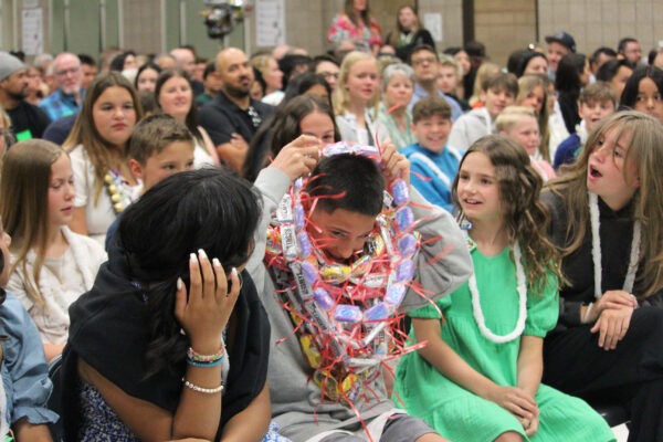 Student covered with leis in honor of his graduation.