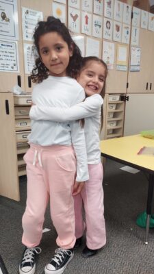 Two students hugging.