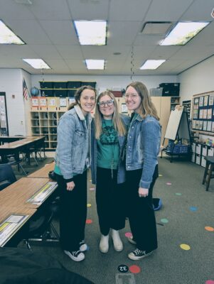 Teachers together in a classroom.